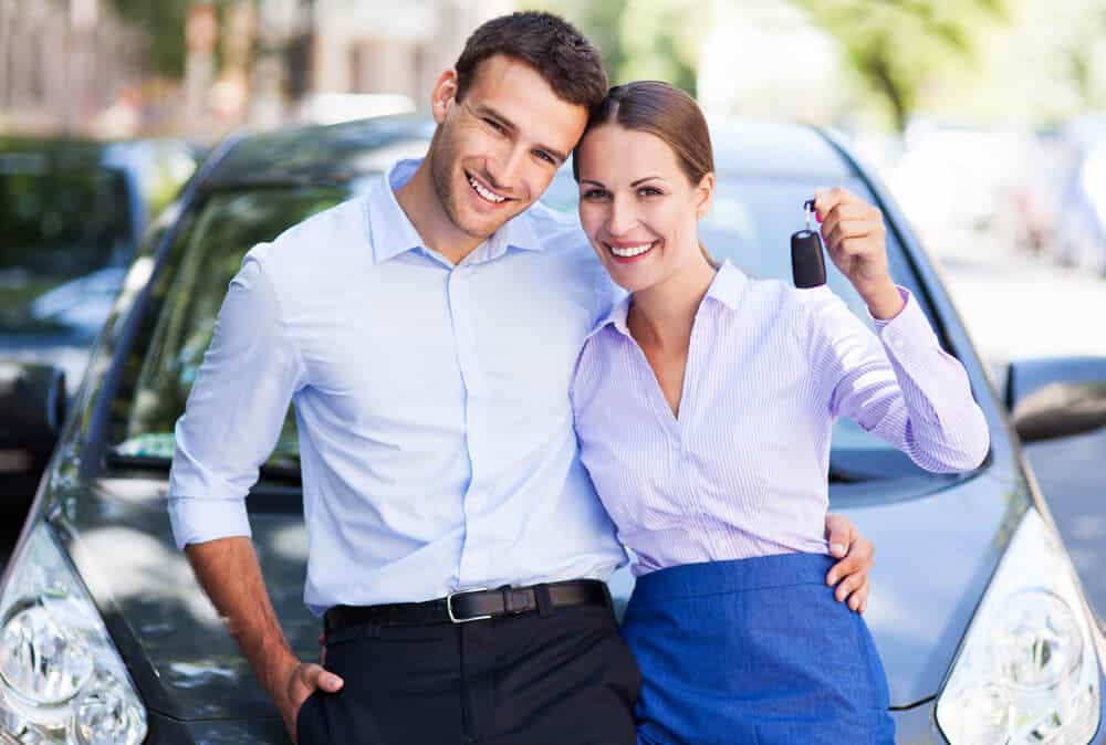 couple being happy about owning a car